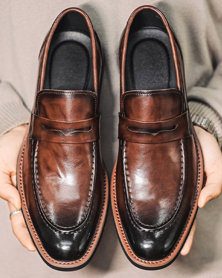 Polished brown leather loafer with strap detail and stitched edge