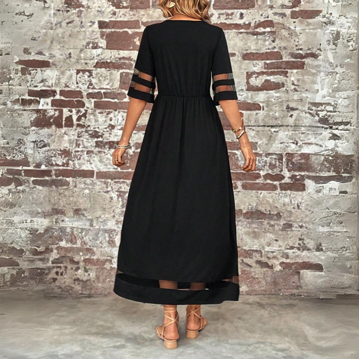 Black midi dress back view with gathered waist, sheer cutout sleeves, and mesh hem panel.