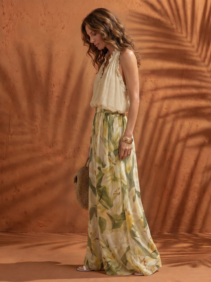 Cream halter sleeveless top with smocked waist and floral wide-leg pants, side view