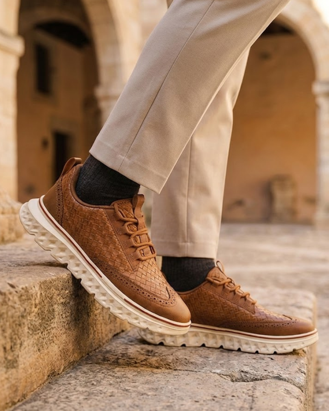 Cognac lace-up dress sneaker with perforated toe and textured leather-look upper