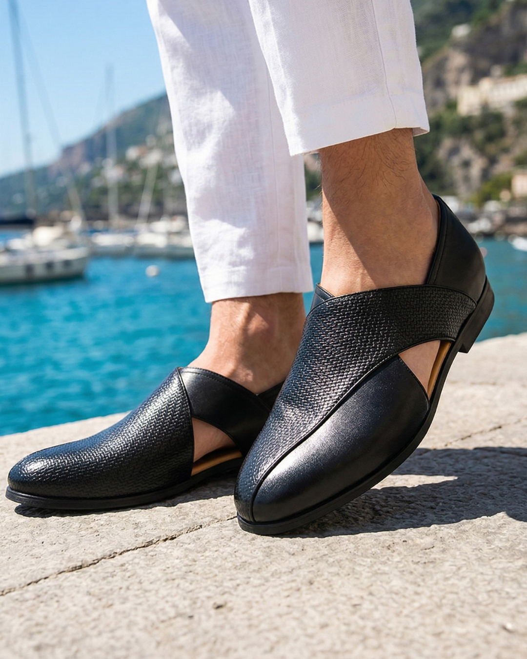 Black slip-on loafers with woven strap, smooth leather toe, and low outsole