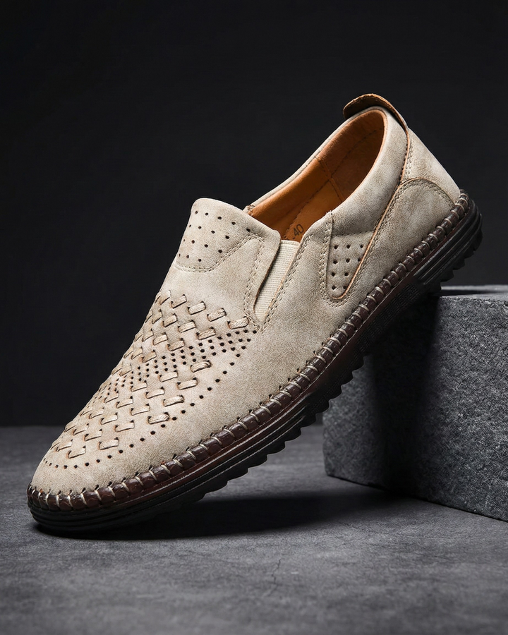 Beige leather loafer with perforated moc-toe design and cushioned collar
