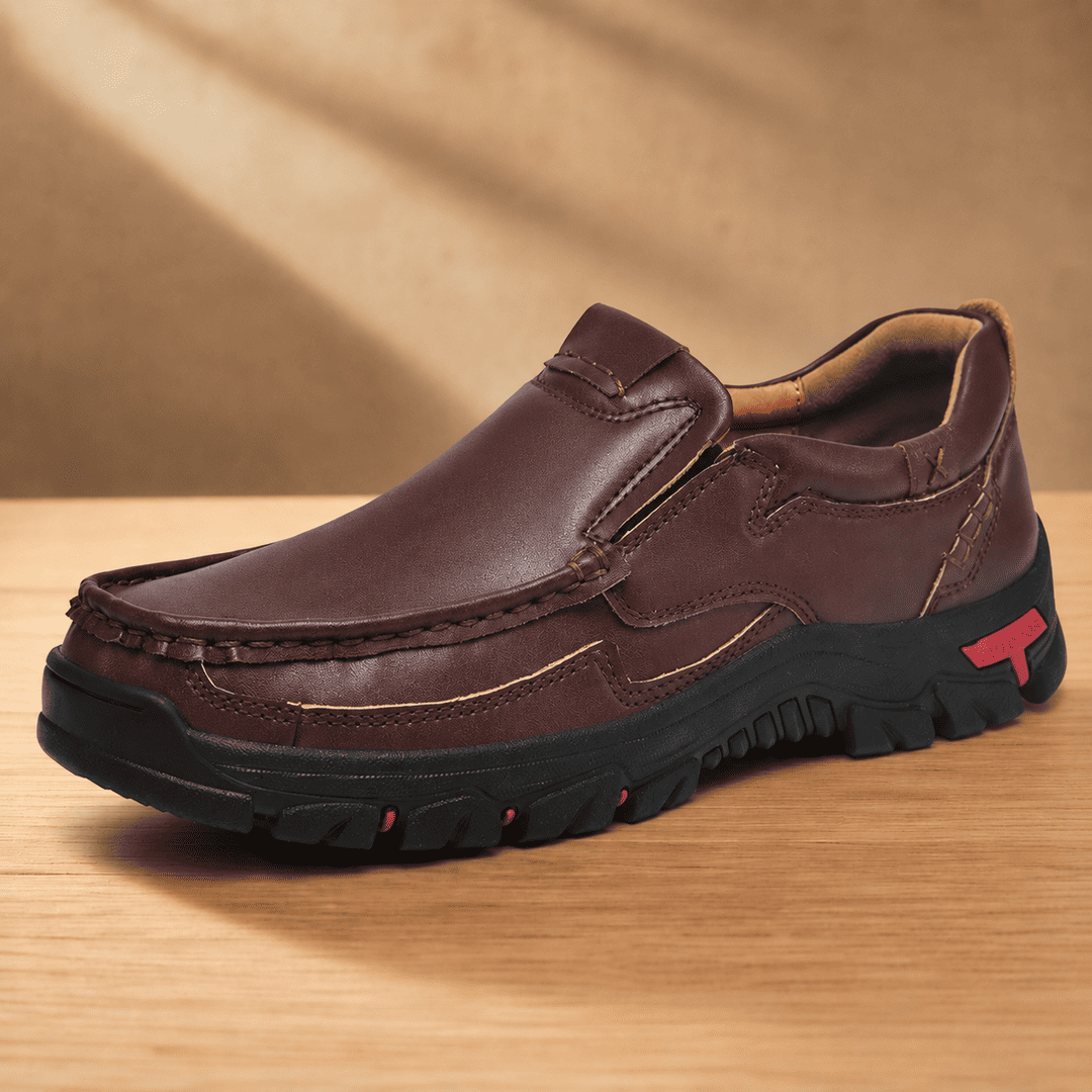 Dark brown slip-on loafer-style shoes with padded collar, rugged tread sole, logo patch