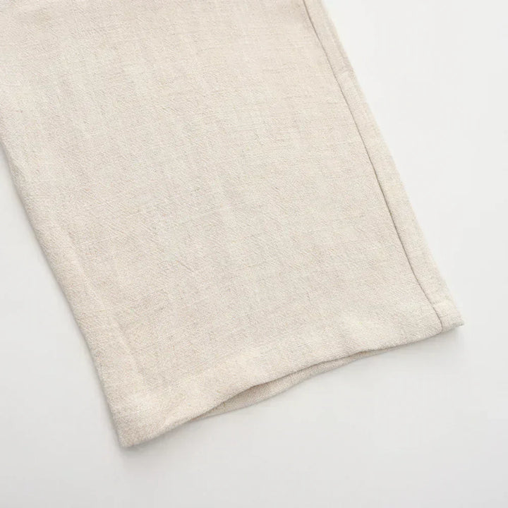 Beige linen pants plain hem detail, relaxed straight leg.