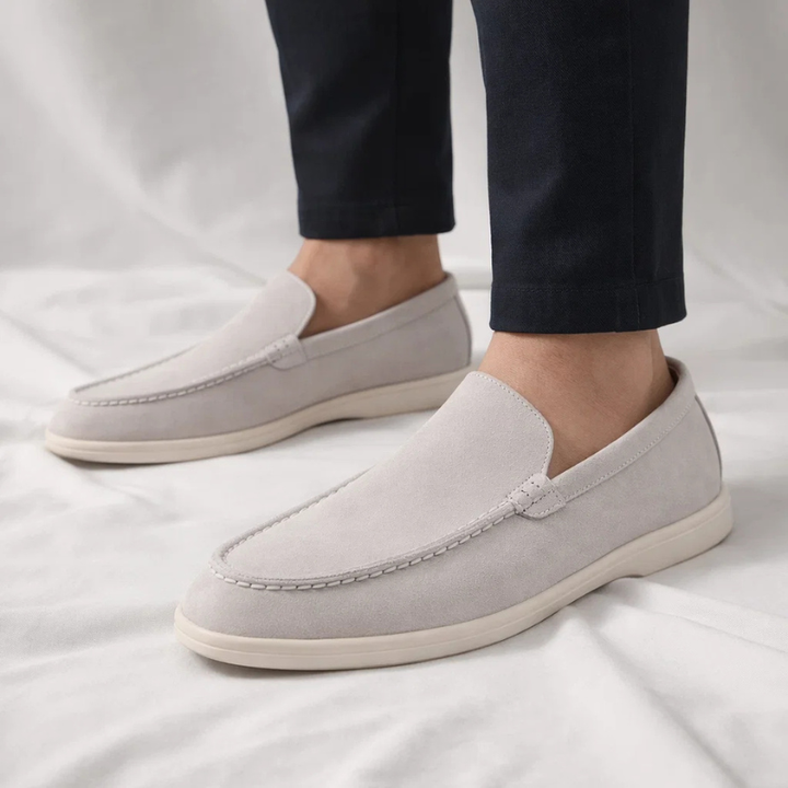 Light gray suede slip-on loafer with stitched vamp and white rubber sole