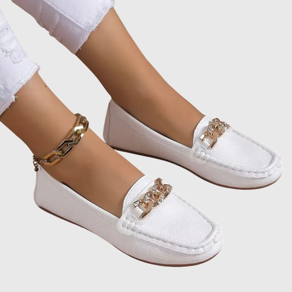 White chain loafers, slip-on style with gold-tone curb chain ornament