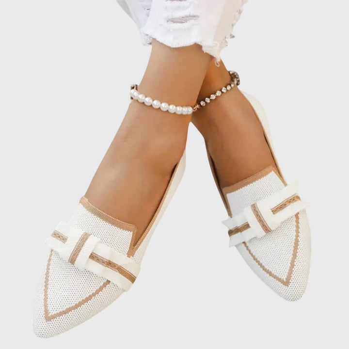 White pointed toe bow flats with brown-edged bow and stitched trim