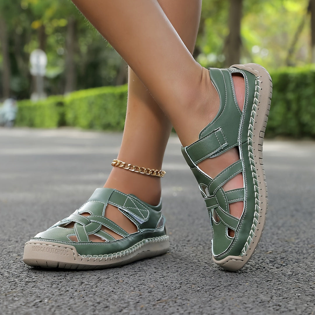 Green cross-strap comfort flat sandals with ankle strap and low cushioned sole