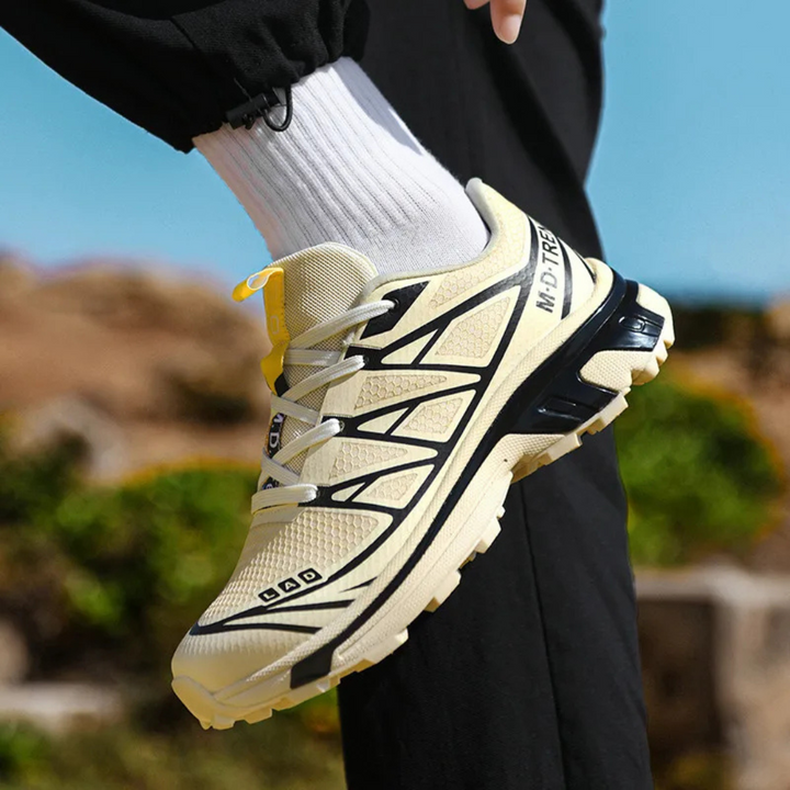 Women’s lace-up walking sneaker in beige and black with yellow pull tab, side view