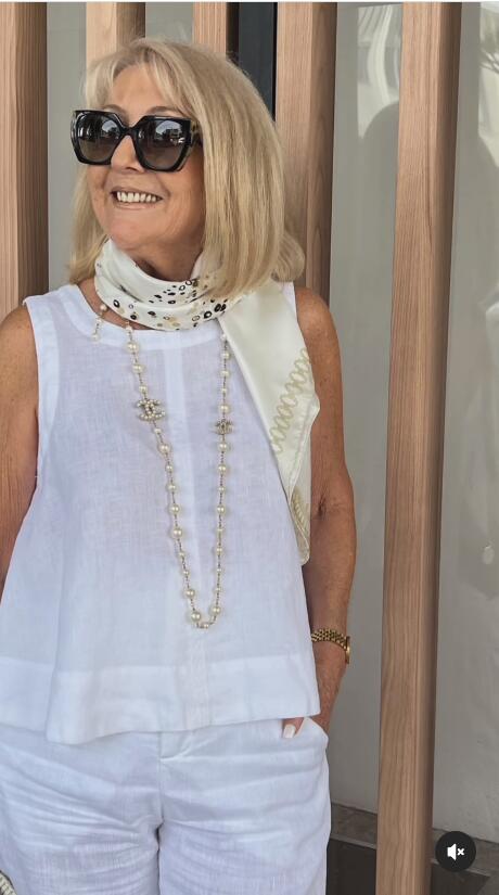White sleeveless layered top with high beaded neckline and long bead detail