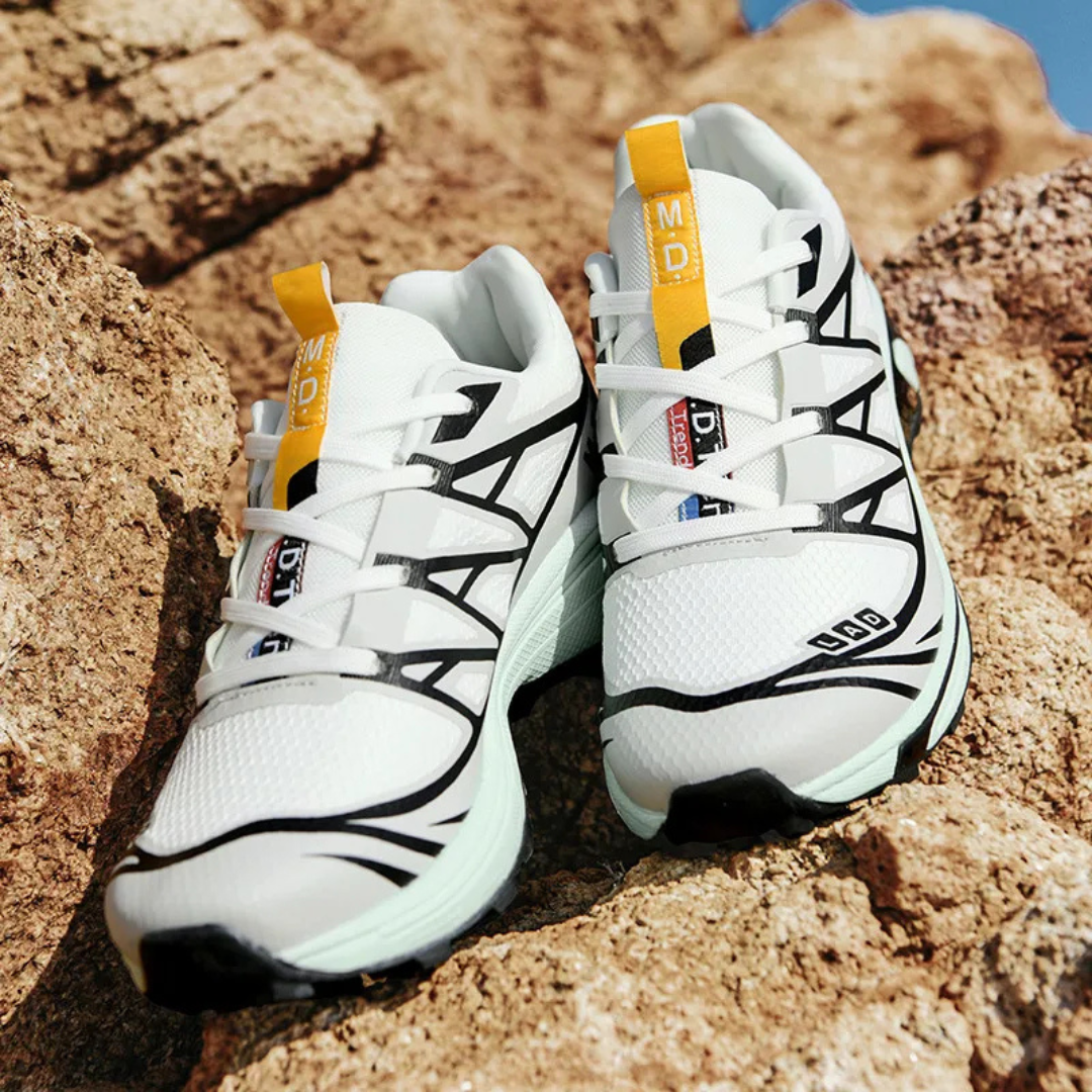 Women’s lace-up walking sneaker pair in white with black panels and teal midsole