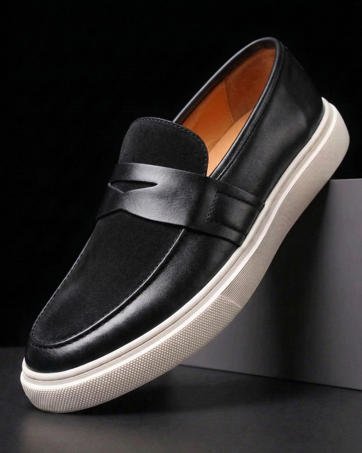 Black leather loafer slip-on with strap detail and white textured sole