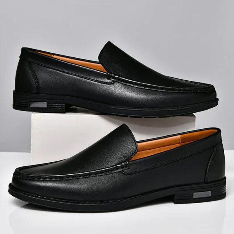 Black leather loafers with metal bit, contrast stitching, and low-profile black sole