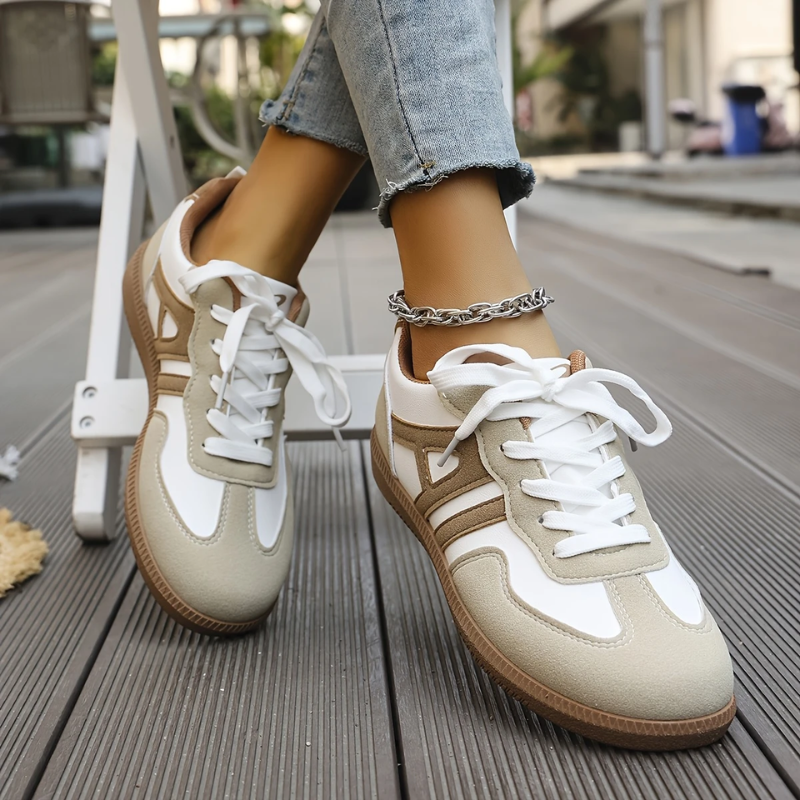 Low top lace-up sneakers, white and tan colorblocked uppers, white laces, gum sole