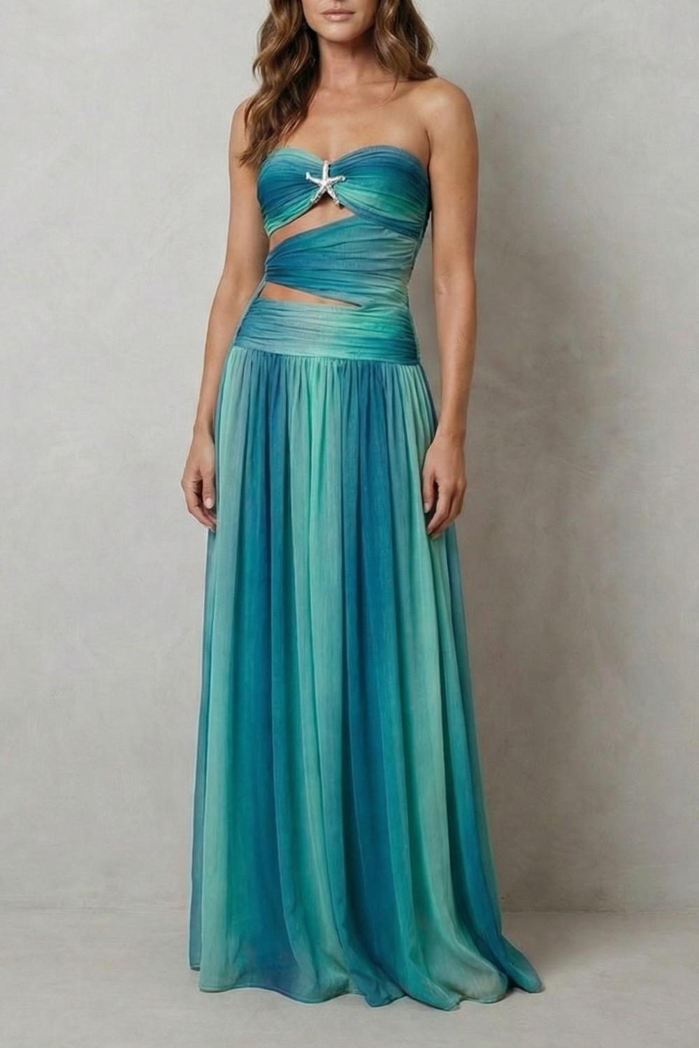 Strapless ombre maxi dress in teal with ruched sweetheart bodice and bow detail.