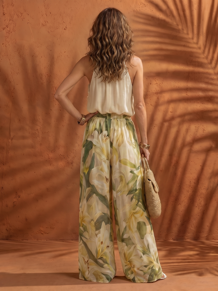 Floral wide-leg pants with elastic waist and cream halter sleeveless top, back view