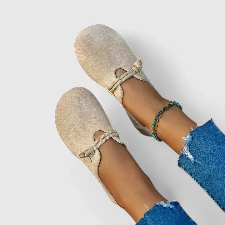 Beige slip-on flats with rope band instep detail and low, rounded toe