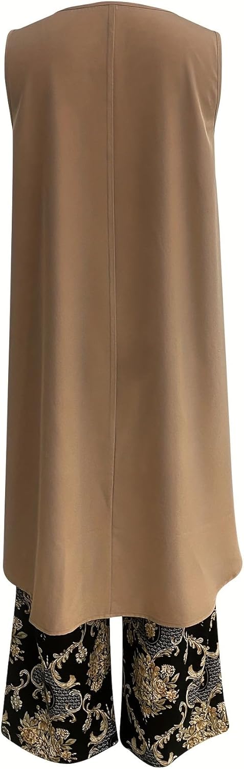 Back of taupe sleeveless tunic with vertical seam and black pants with gold ornate print