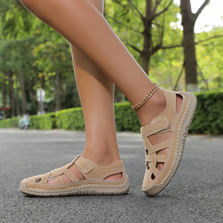 Beige cross-strap comfort flat sandals with ankle strap and low sole