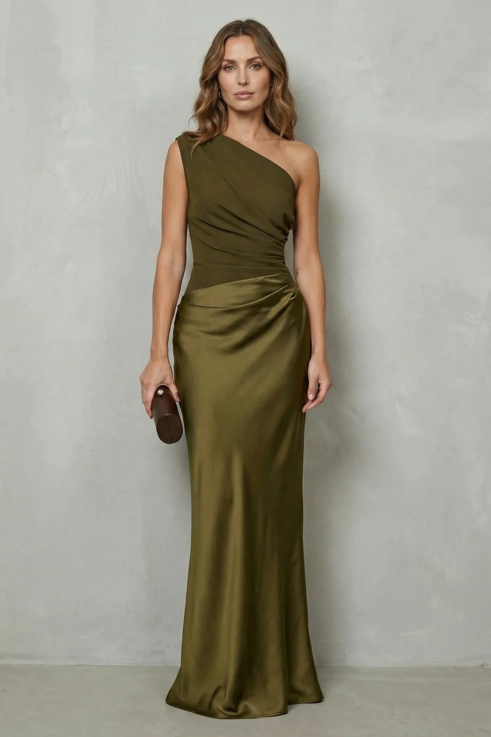 Dark green one-shoulder satin evening gown with diagonal drape and gathered waist