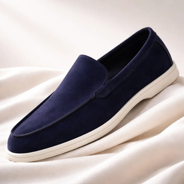 Navy suede loafer with stitched penny collar and low-profile white rubber sole