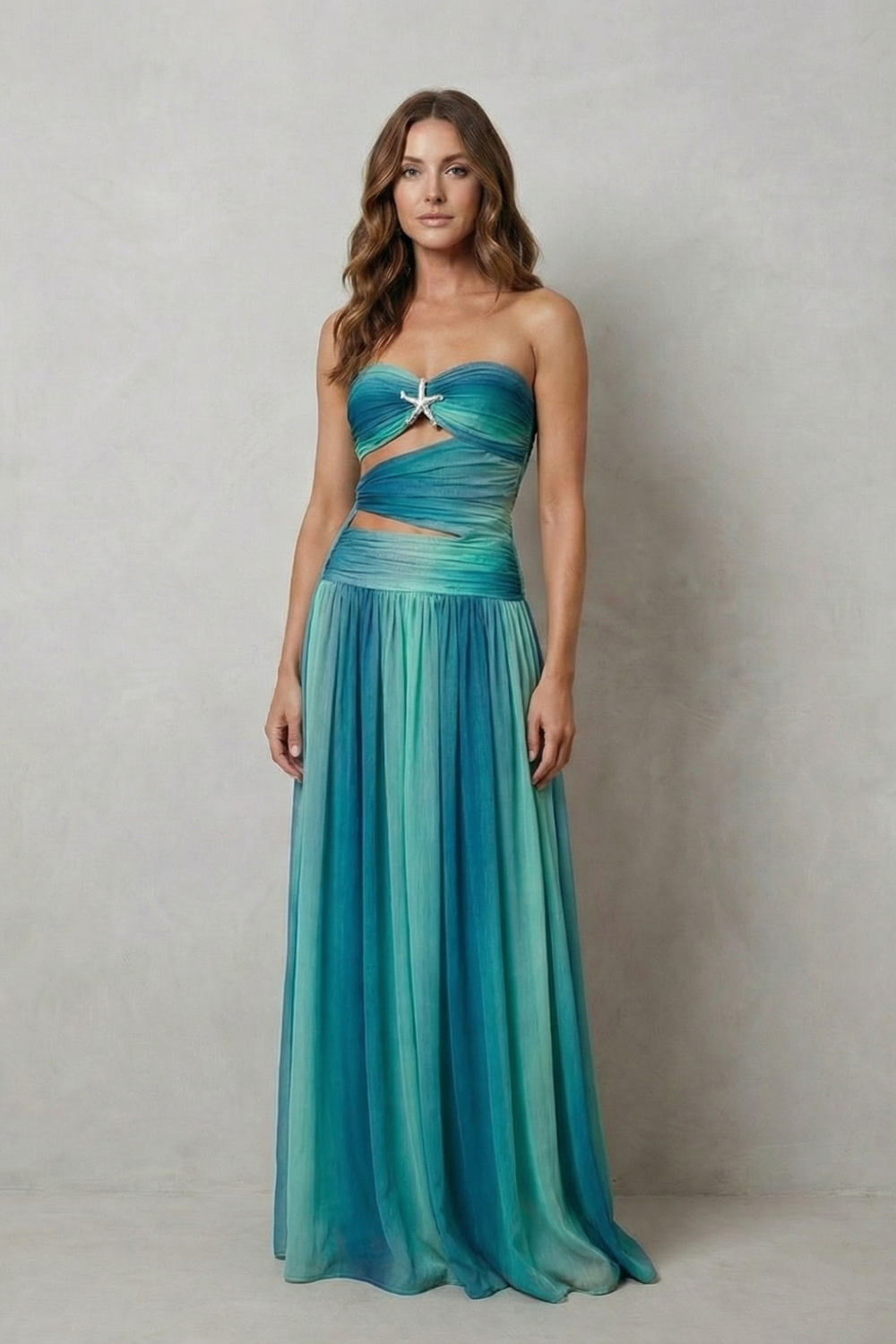 Strapless ombre maxi dress in teal with twisted sweetheart neckline and pleated skirt.