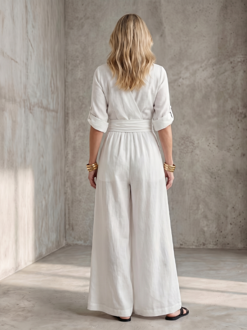 White wide-leg wrap jumpsuit, back view with gathered waist and wide pant legs