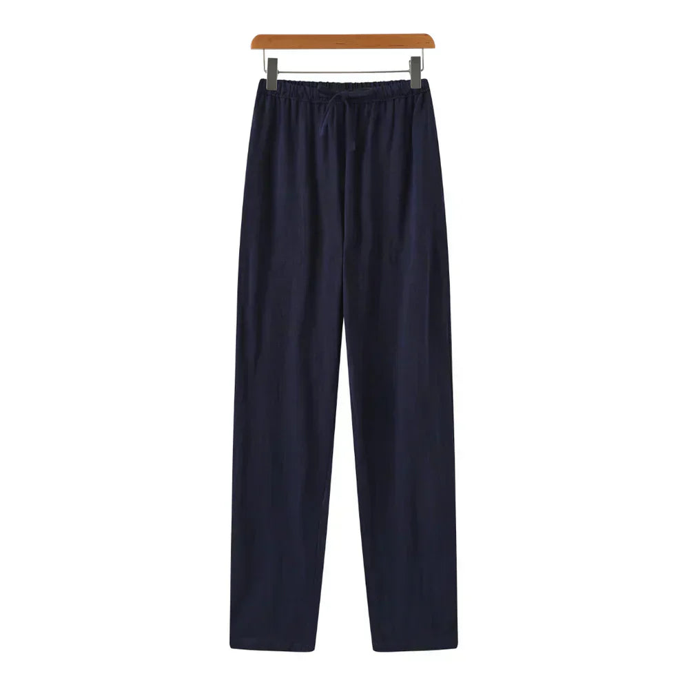 Navy linen pants with elastic waistband, drawstring, and relaxed straight legs.