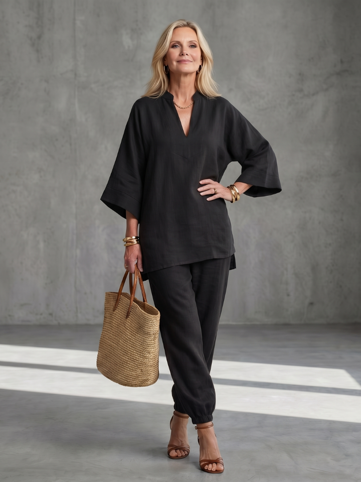 Black women’s V-neck two-piece set with tunic top and relaxed ankle pants, front view
