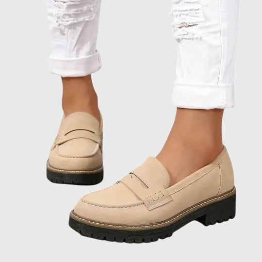 Beige chunky slip-on loafers with strap detail and dark rubber lug sole