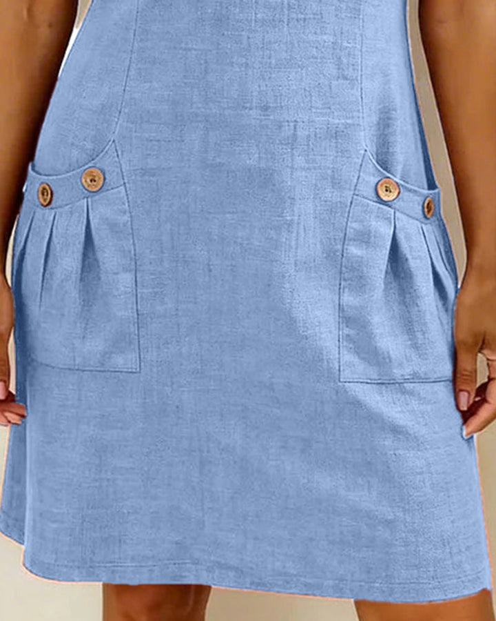 Light blue casual dress showing two front pockets with button accents