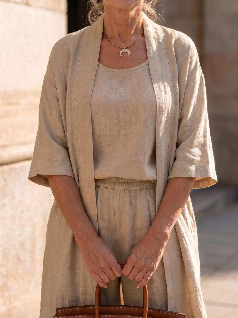 Beige women’s lounge set with short-sleeve top, drawstring pants, and open kimono-style layer