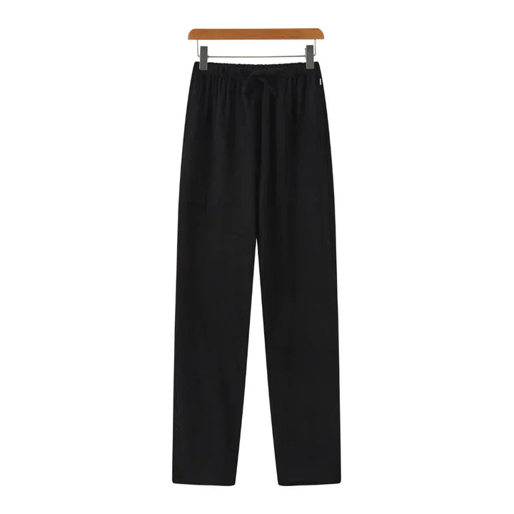 Black linen pants with elastic waistband and drawstring, relaxed straight legs.