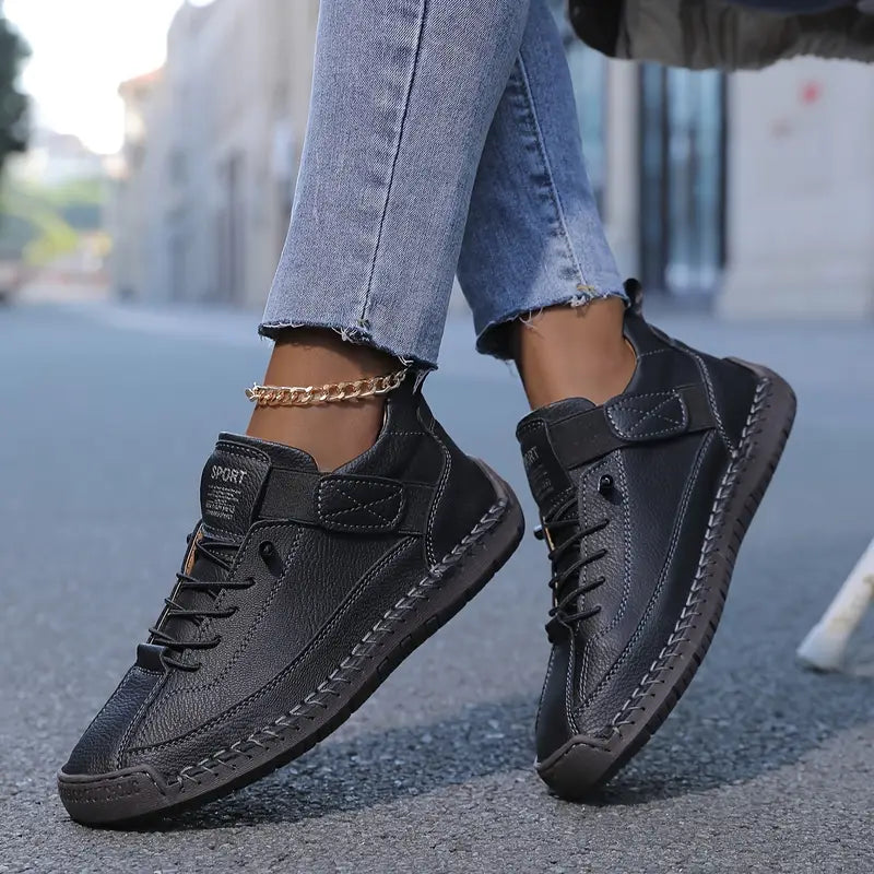 Black orthopedic slip-on sneaker with lace-up front and thick rubber sole