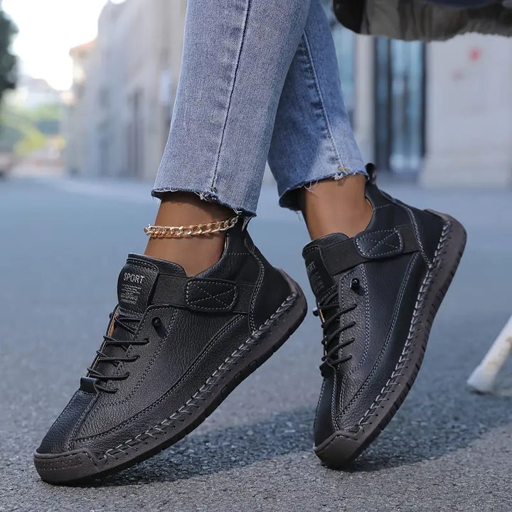 Black orthopedic slip-on sneaker with lace-up front and thick rubber sole