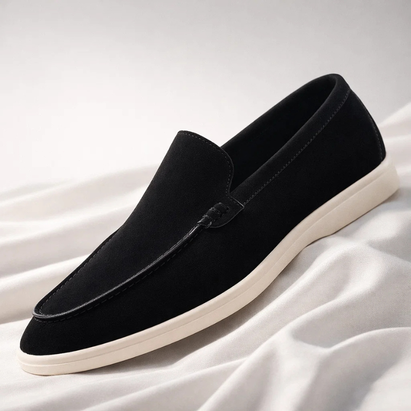 Black suede loafer slip-on with stitched moc toe and cream rubber sole