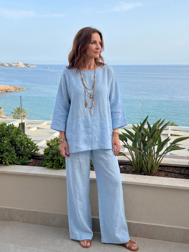 Light blue two-piece set with tunic-style top and wide-leg trousers, full body view
