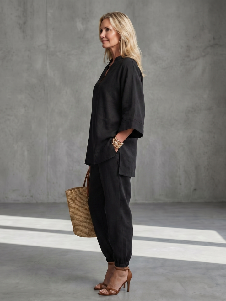 Black women’s V-neck two-piece set with tunic top and relaxed jogger-style pants, side view