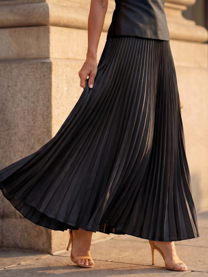 Black pleated midi skirt with accordion pleats and flared hem