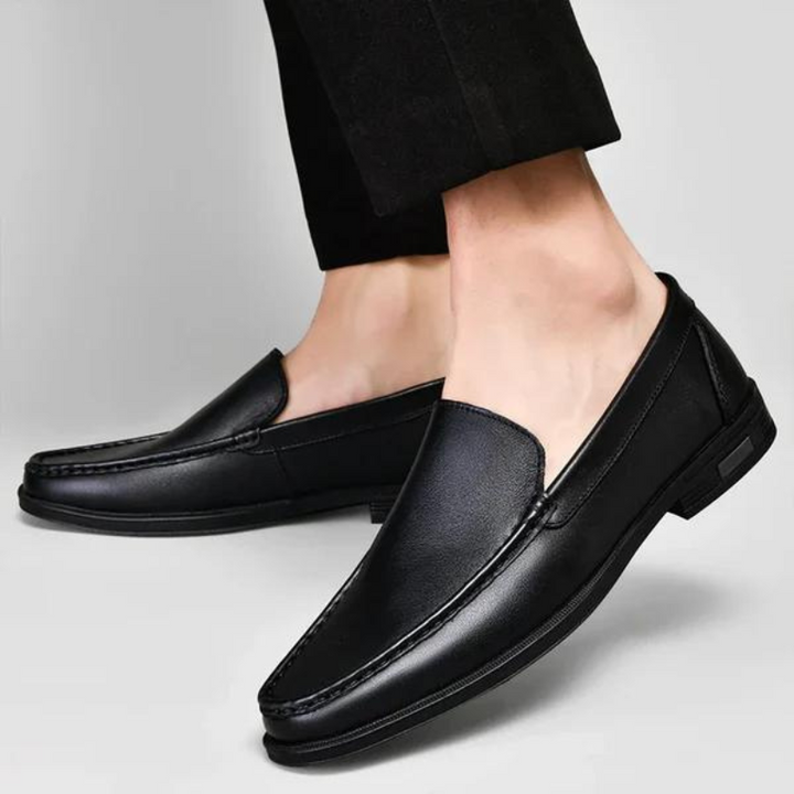 Black leather loafers with metal bit worn with cropped pants, low-profile outsole