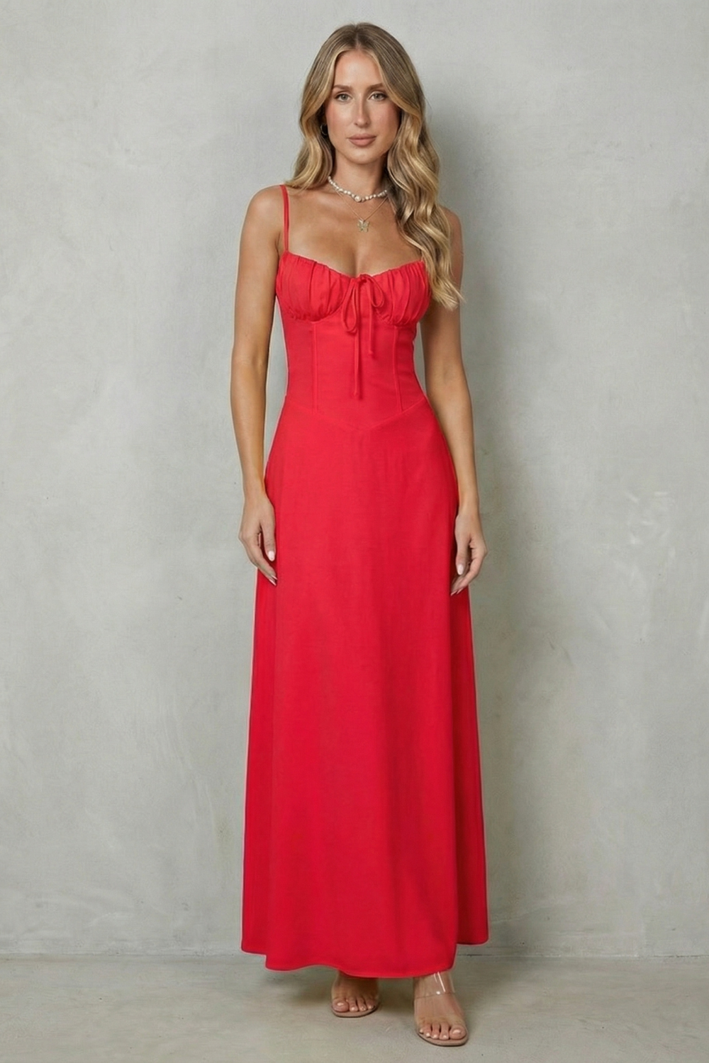 Red corset maxi dress with thin straps and ruched bodice with front tie detail