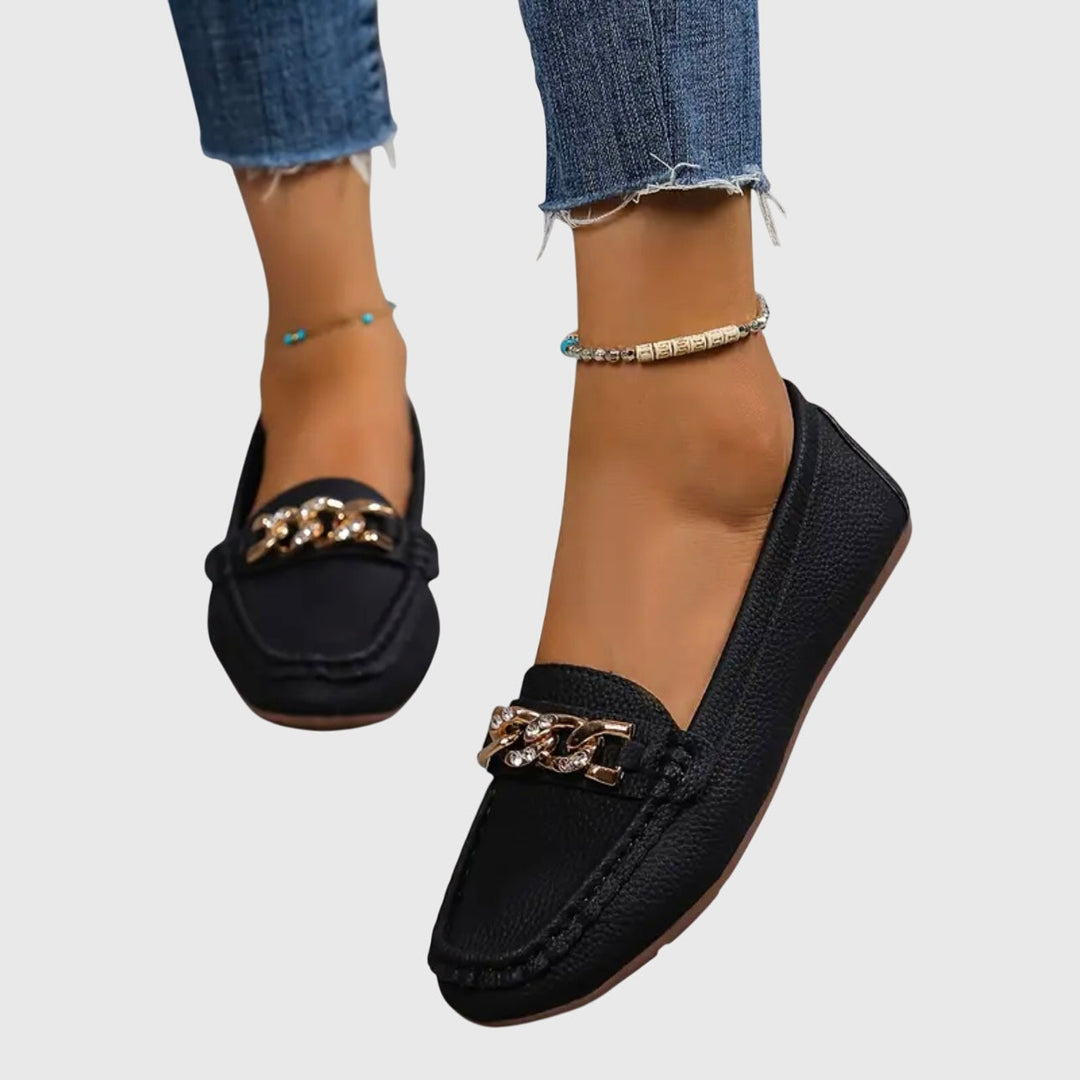 Black chain loafers with gold-tone chain front detail and low wedge sole
