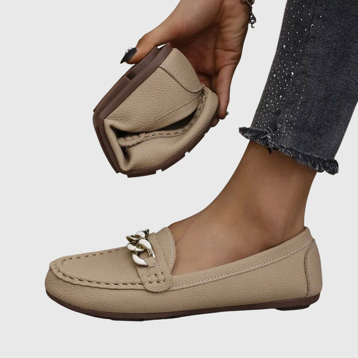 Beige women's chain loafer with metal link detail and stitched moc toe