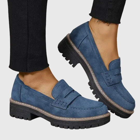 Blue chunky slip-on loafers with strap detail and dark lug sole