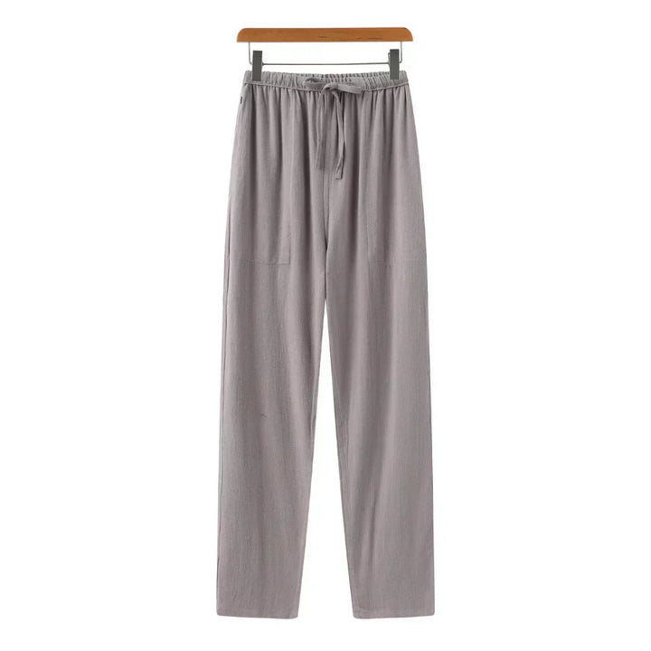 Gray linen pants with elastic waistband and drawstring, relaxed straight legs.