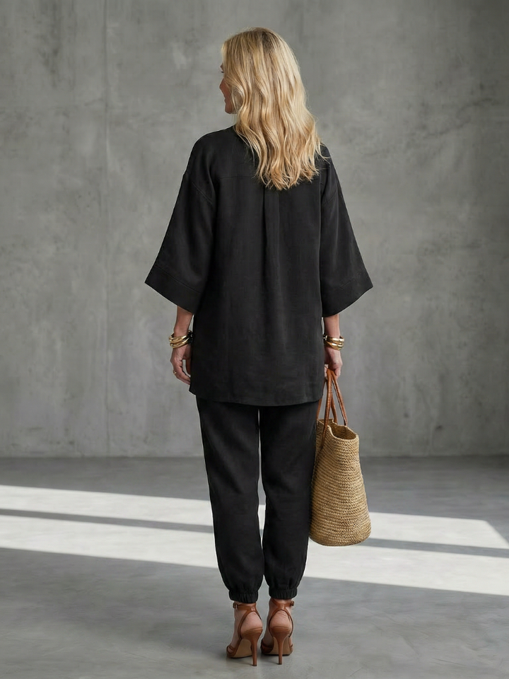 Black women’s V-neck two-piece set with tunic top and relaxed ankle pants, back view