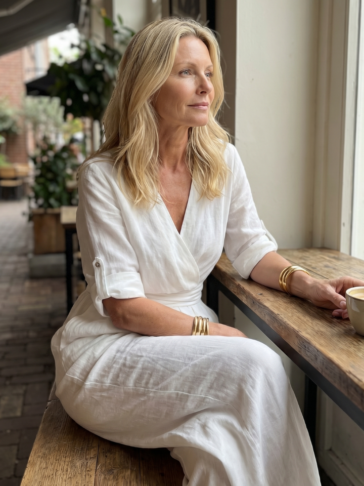 White wrap jumpsuit with V-neck and gathered waist, three-quarter sleeves