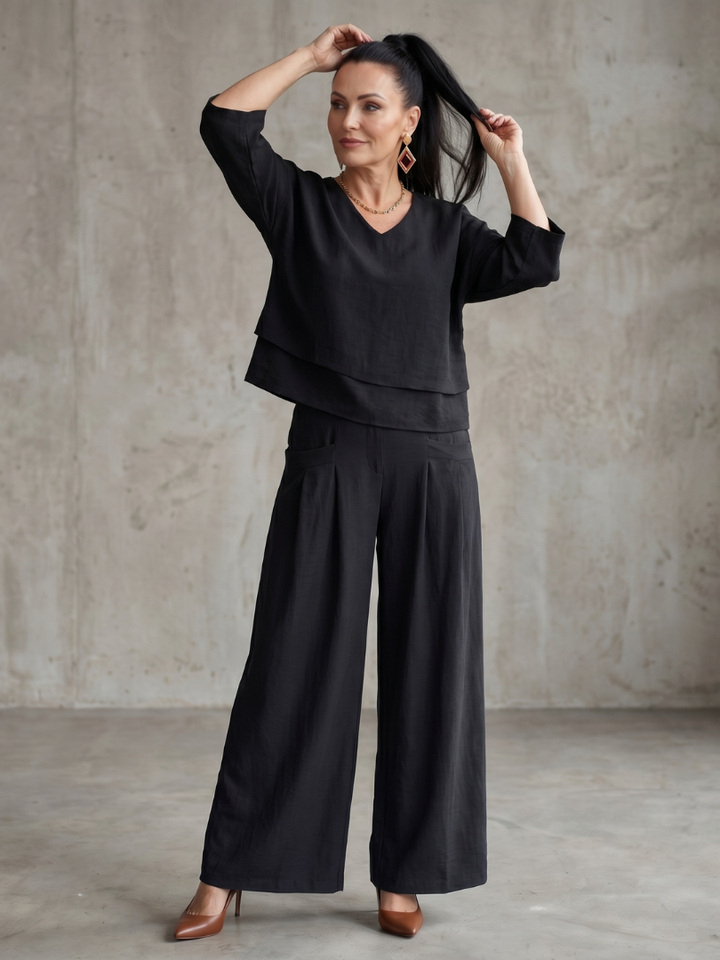 Black two-piece wide-leg pants set with V-neck tunic top and wide trousers.
