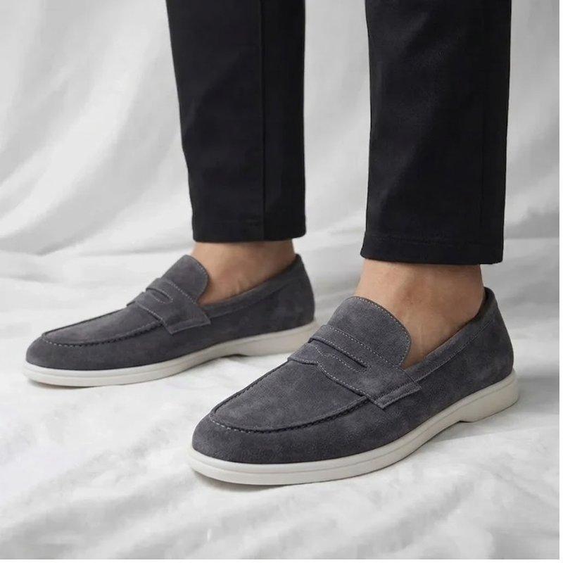 Men's suede loafers in charcoal gray with slip-on strap and white rubber sole