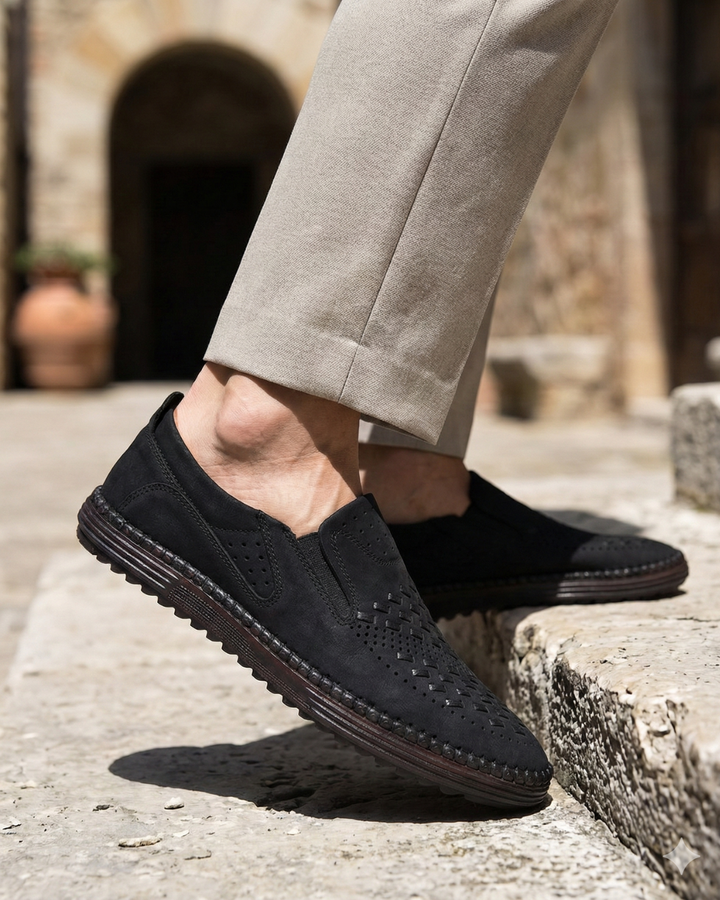 Black perforated leather slip-on loafer with stitched edge and padded vamp